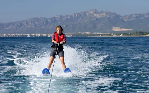 Jeune skieuse en ski nautique devant le massif de l'Esterel